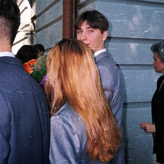 People standing outdoors in formal attire.