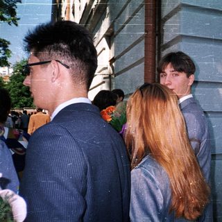 People standing outdoors in formal attire.