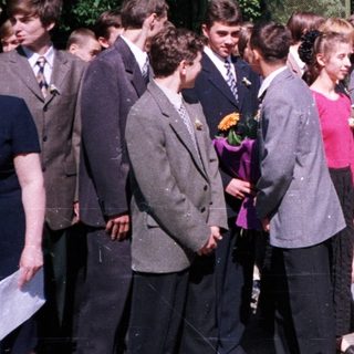 Group of students placing flowers at a monument.