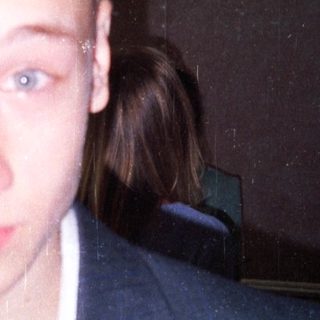 Young man in a suit indoors.