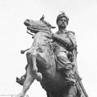 Equestrian statue of a historical figure on a stone pedestal.