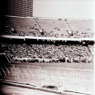 Olympic stadium with track and seated crowd.