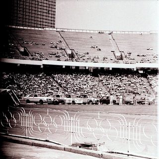 Olympic stadium with track and seated crowd.
