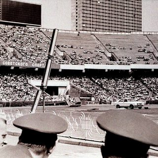 Massive stadium filled with spectators during Soviet-era event.