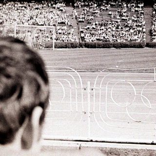 Massive stadium filled with spectators during a sports event.