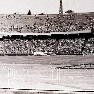 Massive stadium filled with spectators during a sports event.