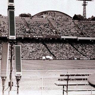 Massive stadium filled with spectators during a football match.