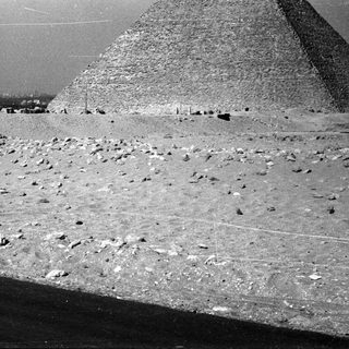 Ancient Egyptian pyramid with desert construction site.