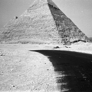 Ancient Egyptian pyramid in desert landscape.