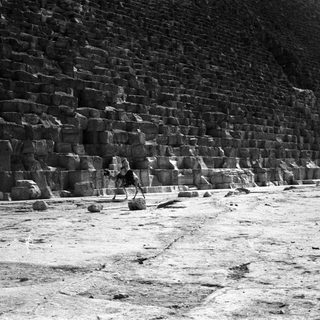 Ancient Egyptian pyramid construction site with stone blocks.