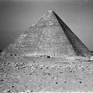 Ancient Egyptian pyramid complex in desert.
