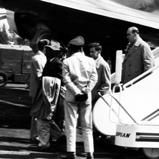 Ethiopian Airlines passengers boarding vintage aircraft.