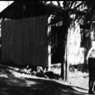Blurred outdoor scene with people near a building.