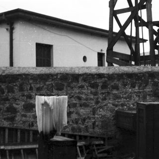 Industrial building with drying fabric and windmill.