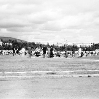 People playing baseball on a field.