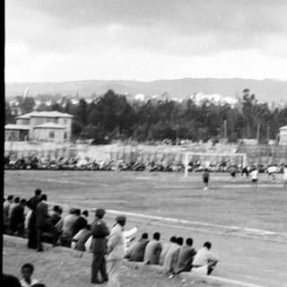 Historic outdoor soccer match with spectators.