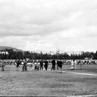 Historic outdoor sports event with spectators.