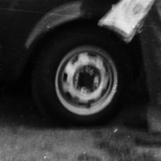 Family loading belongings into a car.