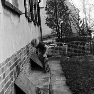 Skateboarder performing trick on stairs.