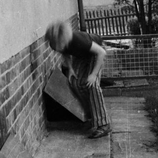 Skateboarder performing trick on stairs.