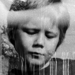 Child outdoors with layered, partially transparent vintage photos.