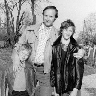 Family portrait outdoors in vintage clothing.