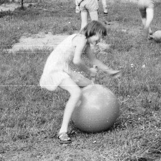 Children playing outdoor games with balls.