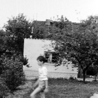 A person running in a backyard.