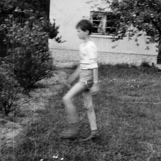 A person running in a backyard.