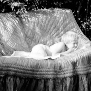 Baby sleeping peacefully in a hanging hammock.