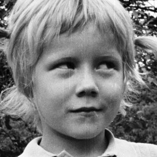 Young child outdoors in casual polo shirt.