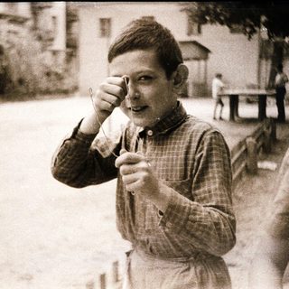 Young boy eating ice cream outdoors.