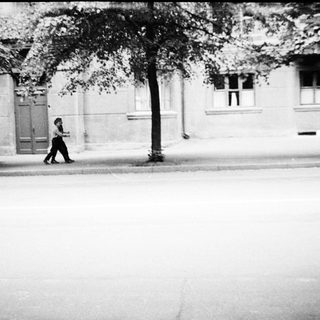 Person walking alone on empty urban street.