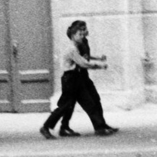 Person walking alone on empty urban street.
