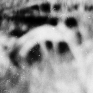 Blurred close-up of textured fabric or surface.