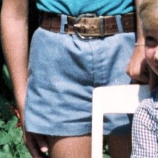 Three children posing outdoors in 1980s-style clothing.