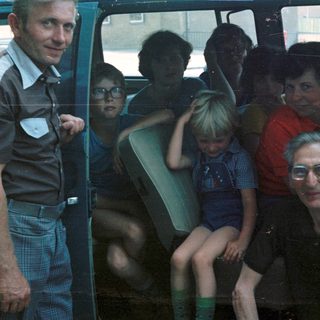 Family group traveling together in a van.