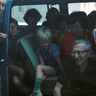Group of people riding together in a bus.