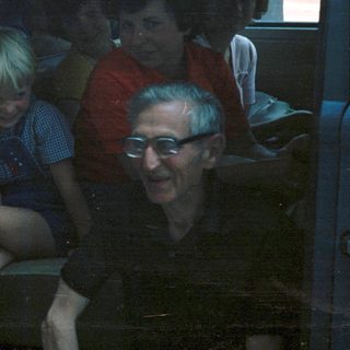 Group of people riding together in a bus.