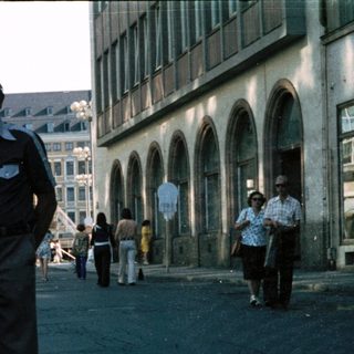 Family group photo in urban street setting, mid-1970s.