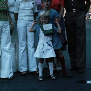 Family group photo in urban street setting, mid-1970s.