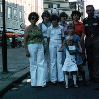 Family group photo in urban street setting, mid-1970s.
