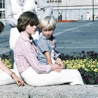 Group photo of adults and children outdoors in 1970s style clothing.