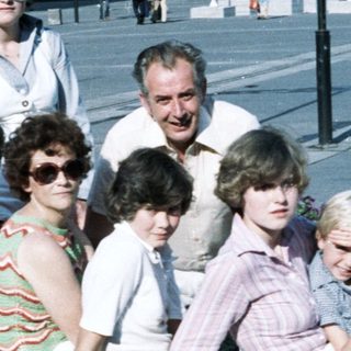 Family group photo in 1980s outdoor setting.