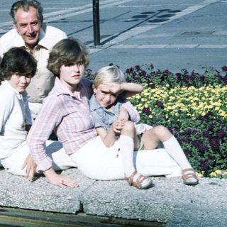 Family group photo in 1980s outdoor setting.