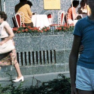 Two children posing near a historic monument.