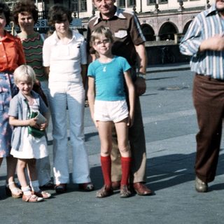 Family group photo in urban square, mid-1980s.