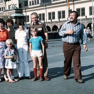 Family group photo in urban square, mid-1980s.