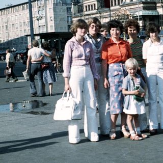 Family group photo in urban square, mid-1980s.
