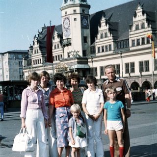 Family group photo in front of historic town square clock tower.